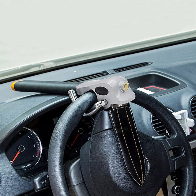 "High-visibility silver-black steering wheel lock with universal fit, durable steel-aluminum build, protects from theft."