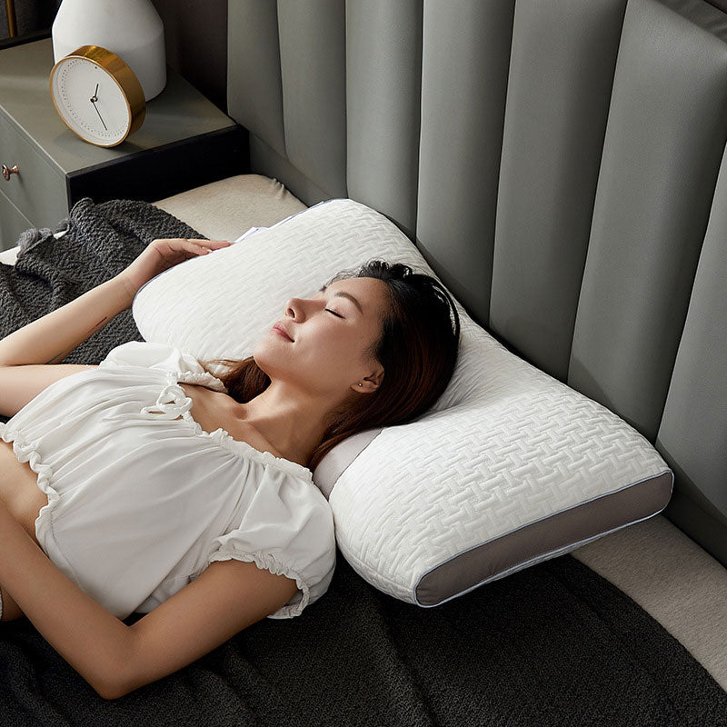 Hybrid pillow with ergonomic design, suited for back and side sleepers, featuring a neutral aesthetic and neck support.