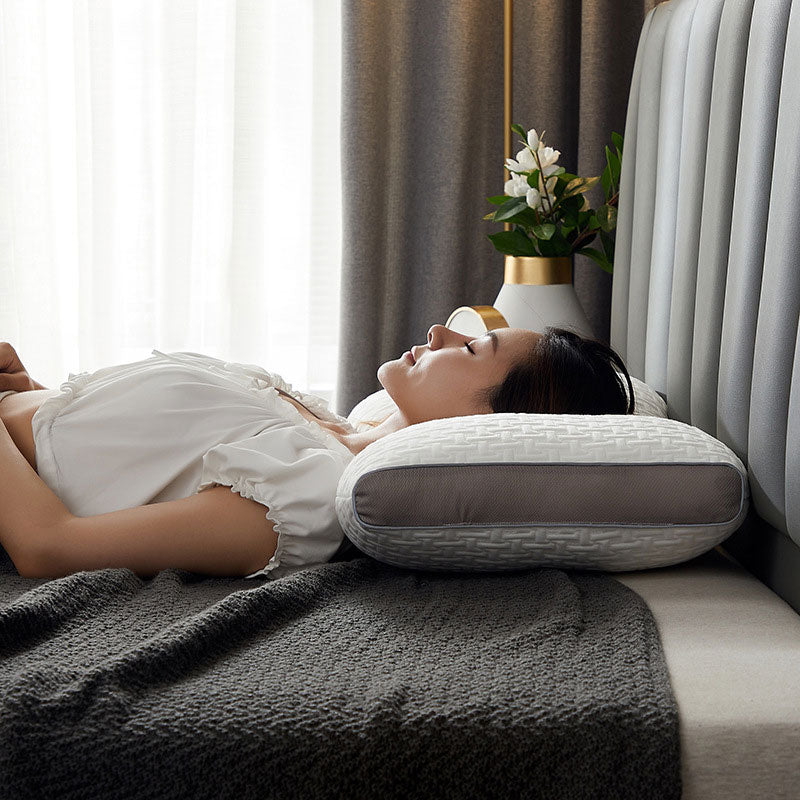 Hybrid pillow with ergonomic design, suited for back and side sleepers, featuring a neutral aesthetic and neck support.