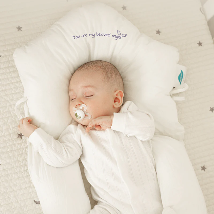 Hypoallergenic infant sleep pillow offers gentle head support for safe, comfortable rest in nursery bedding. Newborn & toddler safe.
