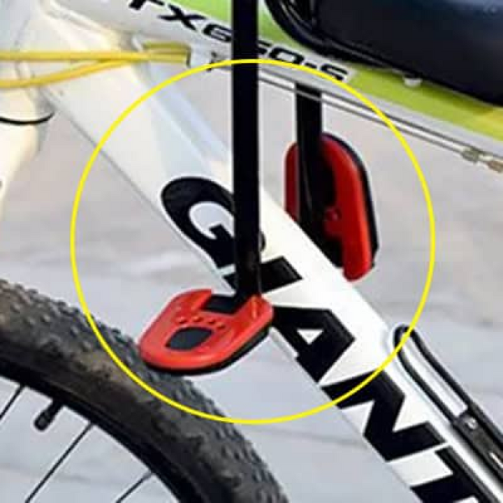 "Kids child bike seat in vibrant red and black with safety harness and padded seat, designed for adult bicycles."