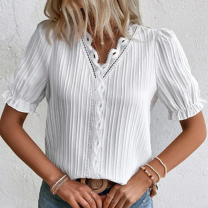 Lace V-neck blouse with short puffed sleeves, pleated fabric, women's elegant clothing, front view.
