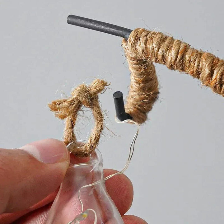 "LED Moon Star Night Light with hemp rope, moon-shaped, emits warm glow, ideal decor for cozy rooms, rustic charm."