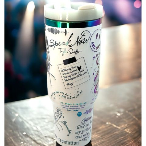 "Limited edition stainless steel tumbler with custom design, handwritten lyrics, vibrant colors, and ergonomic handle."