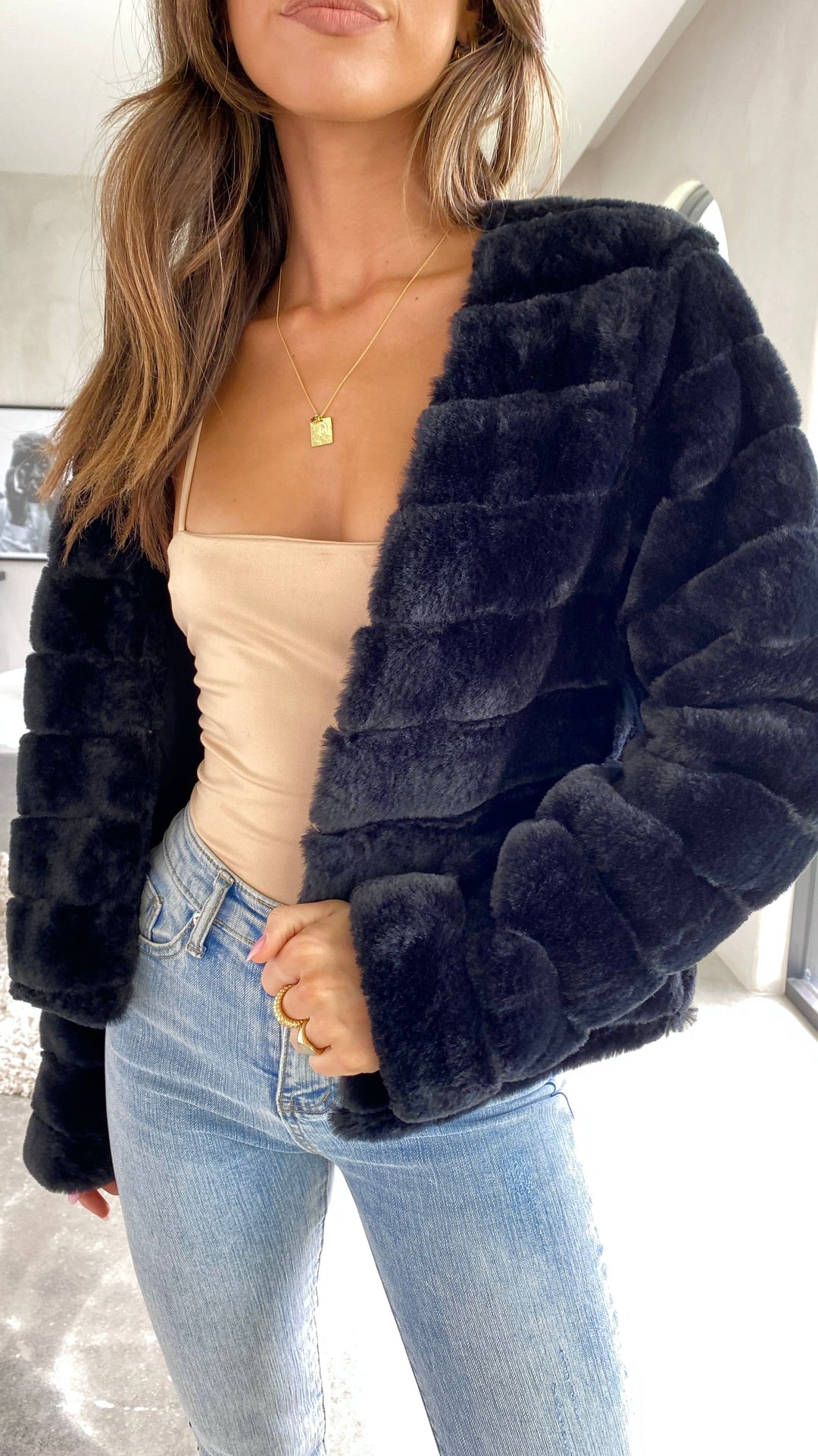 Model wearing a chic Veloura women's cropped jacket, versatile outerwear.