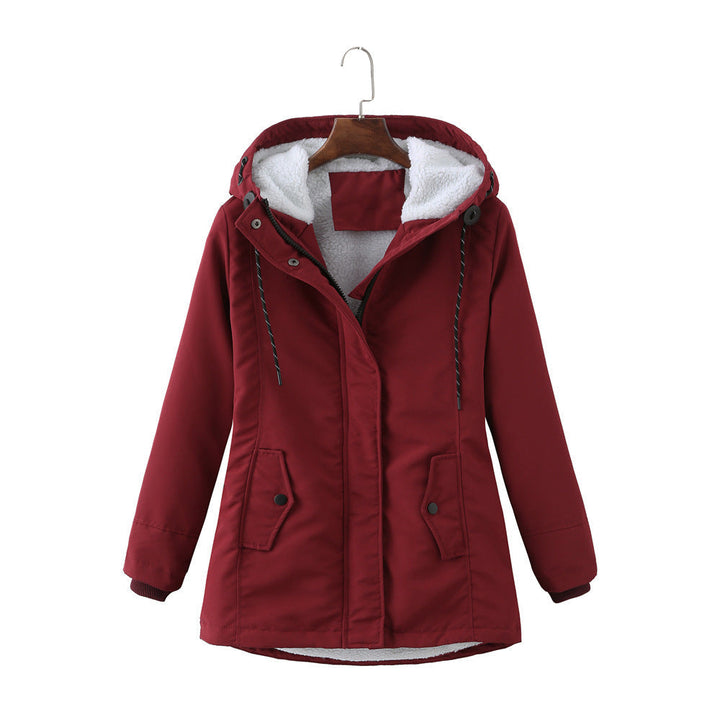 Woman modeling luxurious Aurora winter parka, warm and stylish outerwear for cold weather fashion.