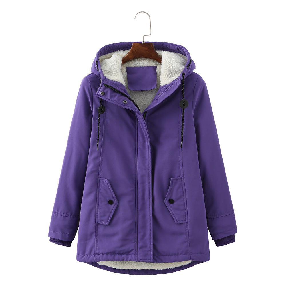 Woman walking outdoors in a warm Aurora winter parka, stylish cold weather jacket for urban fashion.