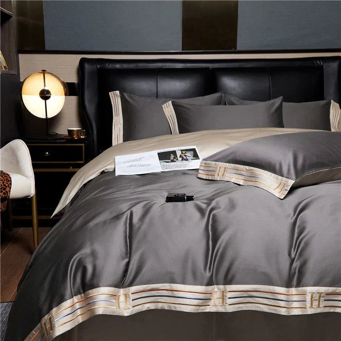 Luxury embroidered cotton bedding set with duvet cover, sheets & pillowcases for elegant bedroom.