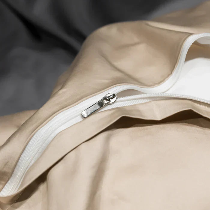 Elegant embroidered pattern on soft cotton bedding set, perfect for modern bedroom aesthetics.