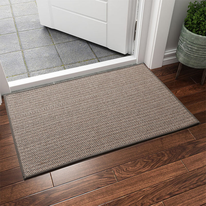 Machine washable woven indoor door mat with a timeless weave pattern, non-slip backing, and plush polypropylene surface.