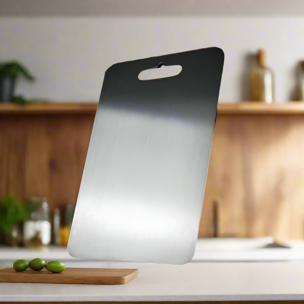Medical grade titanium cutting board with non-porous silver surface, rounded edges, and ergonomic design for ultimate hygiene