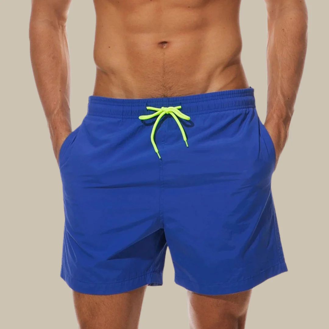 Versatile men's swim shorts with adjustable drawstring waist & practical pockets, perfect for summer comfort & beach style.