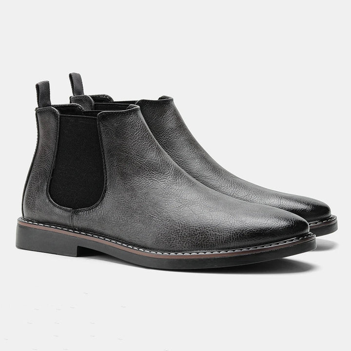 Durable sole of men's slip-on black Chelsea boots, designed for comfort and traction in everyday wear.