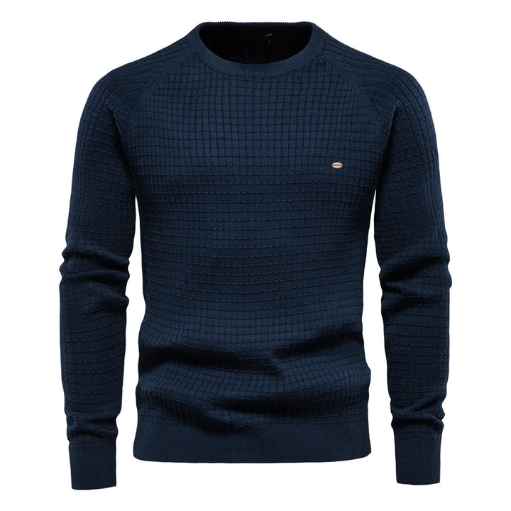 Stylish man wearing a grey Felix crewneck jumper with chinos. Versatile men's pullover for smart casual style.