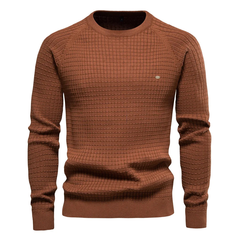 Confident man in a black Classic Everyday Jumper. A timeless, comfortable men's winter sweater pullover.