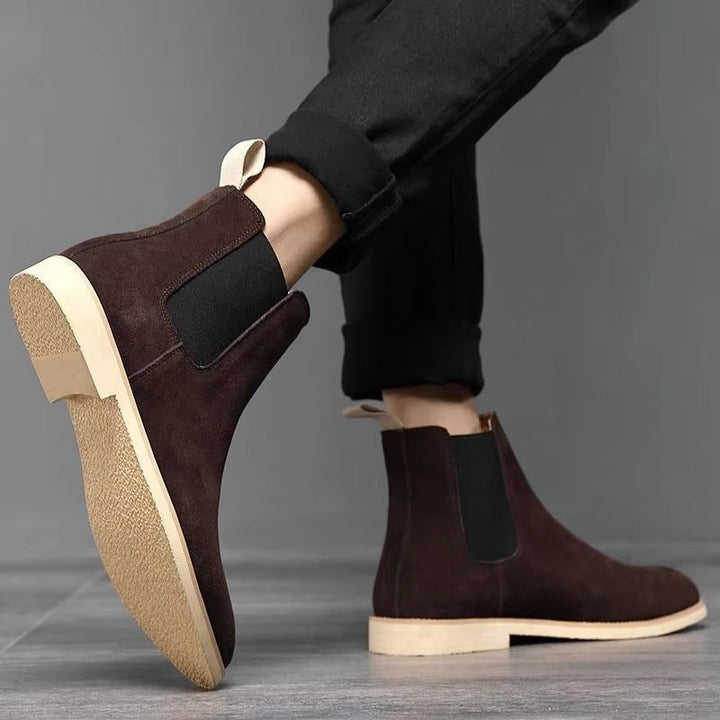 Stylish men's black leather Chelsea boots with pull-on design for easy wear, ideal for office or fall fashion.