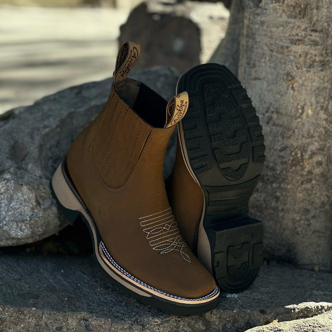 Stylish men's Western ankle boots with intricate embroidery. Classic pull-on cowboy boots for rugged, casual fashion.