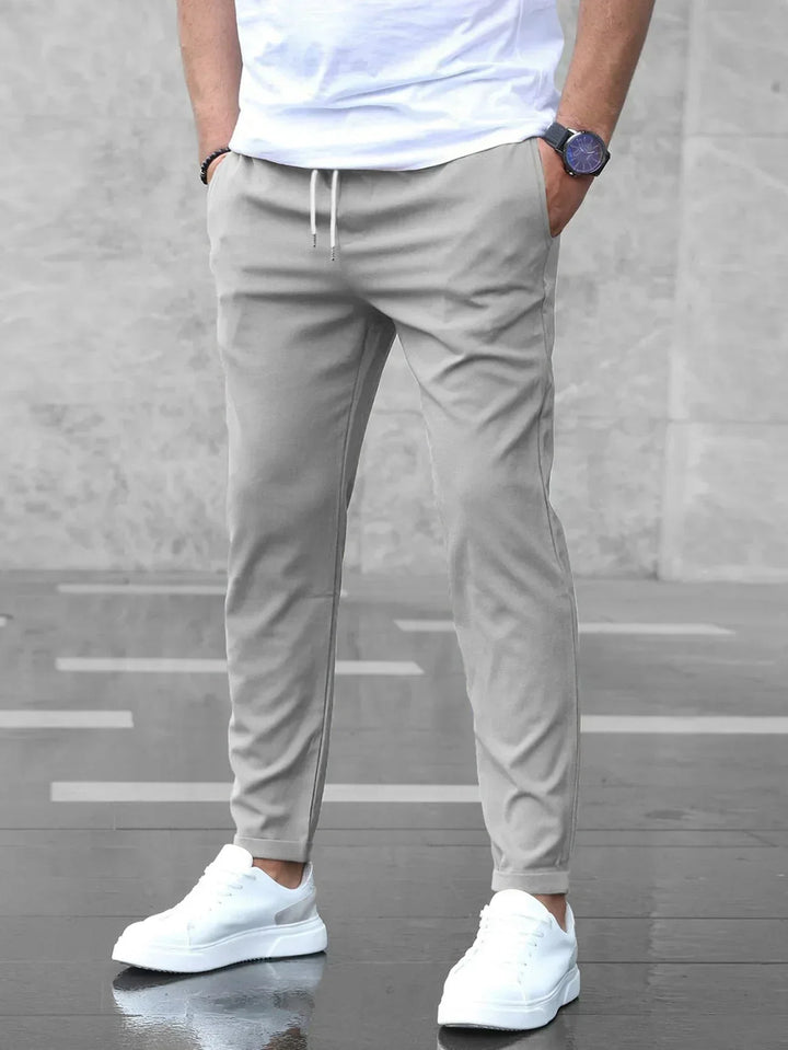 Men's slim-fit stretch trousers in gray, versatile for business casual and everyday comfortable wear.