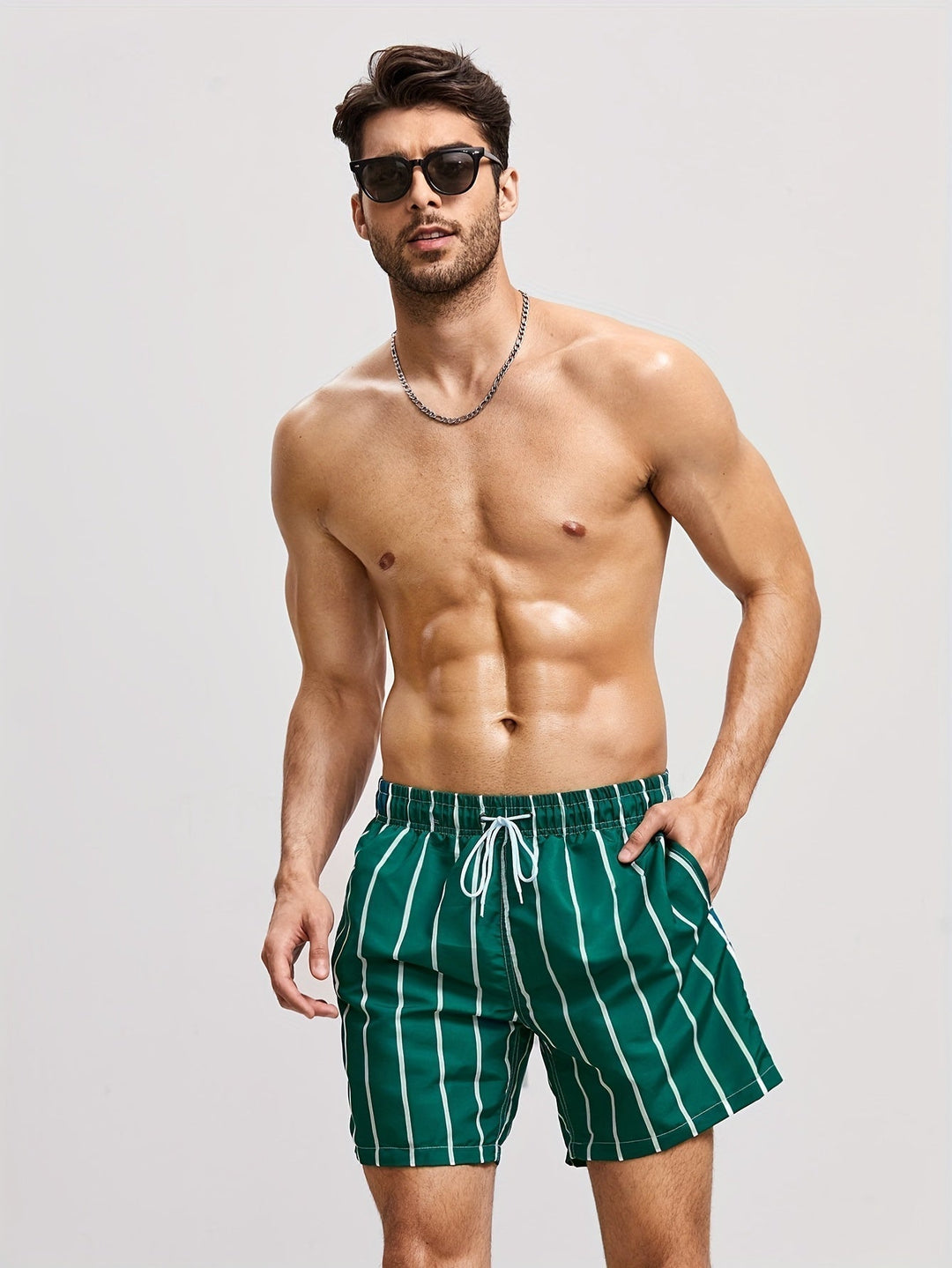 Men's striped swim shorts on model, showcasing adjustable drawstring waist & relaxed fit.