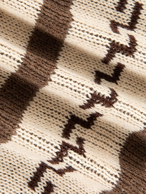 Neatly folded men's geometric pattern zip cardigan, ready for display, showcasing its design and texture.