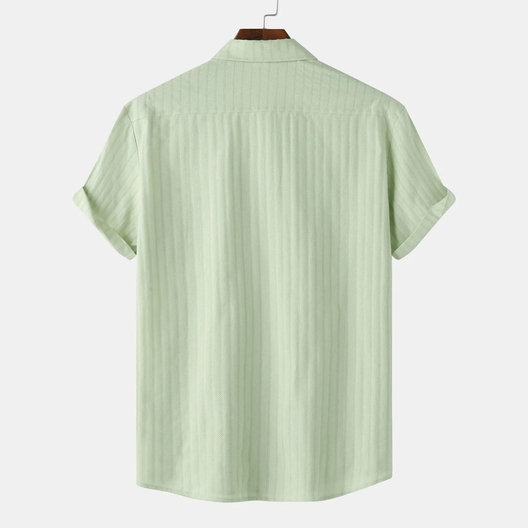 Light blue men's casual button-down shirt. Short sleeve, collared for summer fashion.