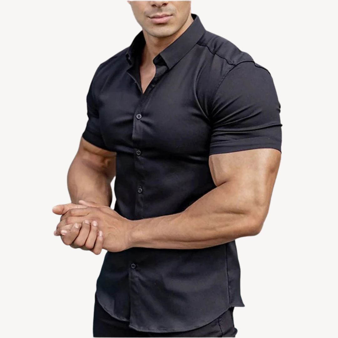 "Men's black muscle fit shirt, cotton spandex, short sleeve, highlighting athletic build, ideal for versatile styling."