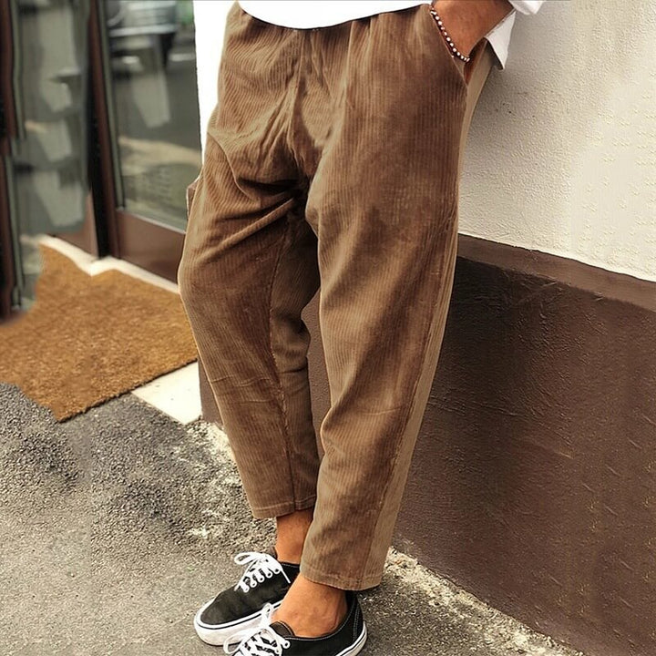 Men's corduroy trousers in green, side view showcasing casual elegance, perfect for versatile styling and comfort.