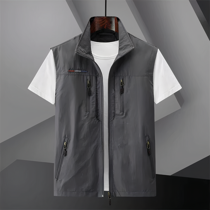 Men's cotton utility vest with multi-pockets, shown in black; ideal for outdoor activities like hiking and fishing.