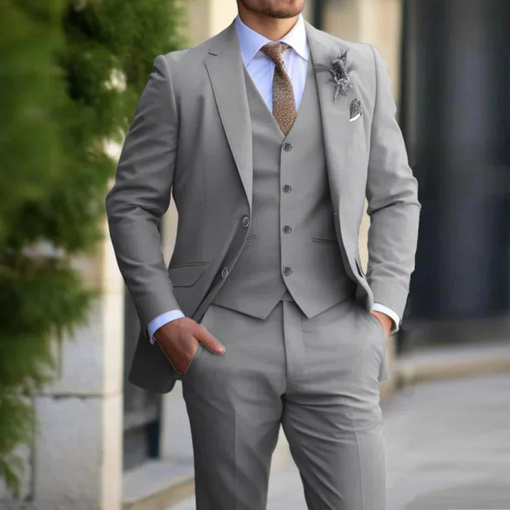 Men's elegant 3-piece slim fit suit in beige; includes blazer, vest, trousers. Ideal for formal occasions. Sophisticated styl