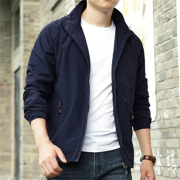 Men's lightweight breathable all-season jacket, sleek design, dark color, highlighting its comfort and versatility for layeri