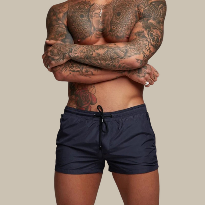 "Men's quick-dry, stretchy swim shorts with pockets in vibrant colors, featuring an elastic waistband and sleek design."