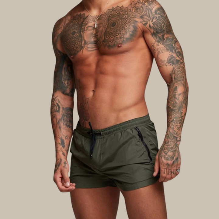 "Men's quick-dry, stretchy swim shorts with pockets in vibrant colors, featuring an elastic waistband and sleek design."