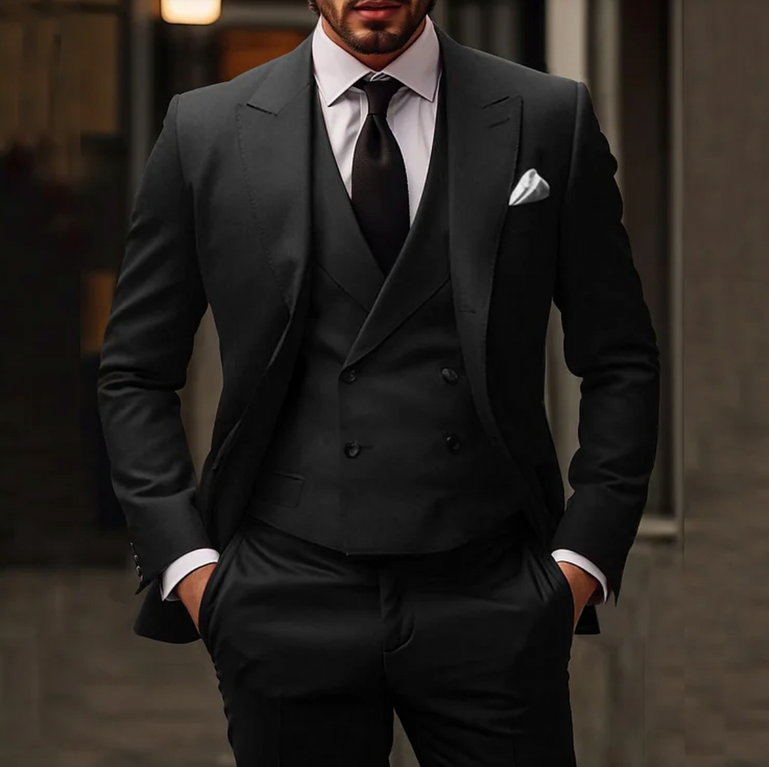 Men's tailored suit with single-breasted jacket, double-breasted vest, and slim trousers in formal stylish design.