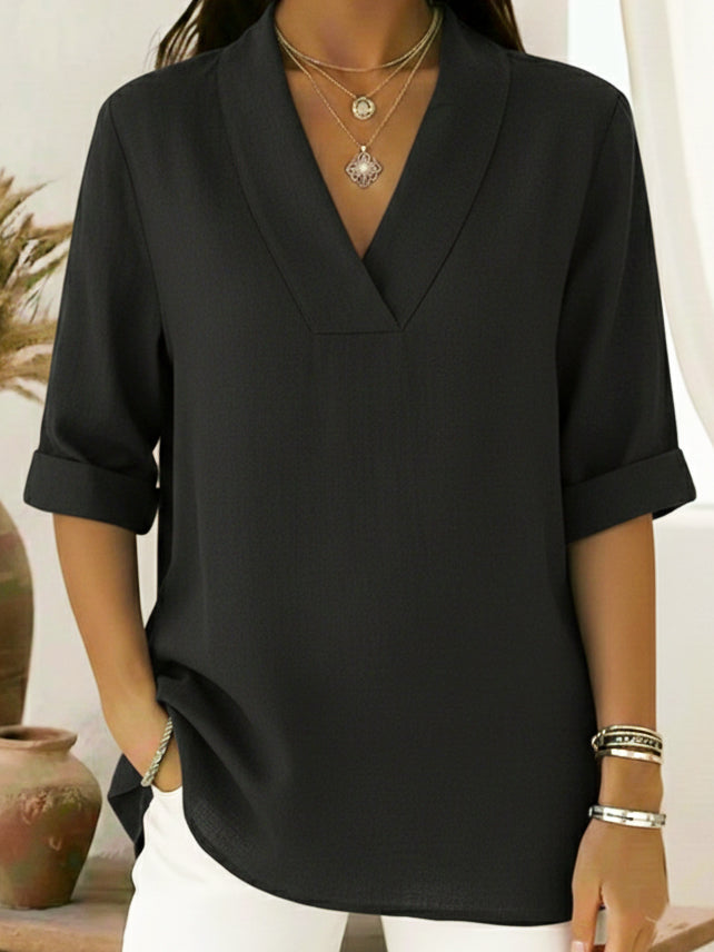Relaxed fit V-neck blouse for women, featuring chic roll sleeves. Comfortable and stylish for any occasion.