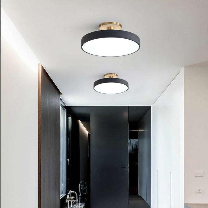 "Minimalist LED ceiling light, semi-flush design, brightens spaces with elegant style and energy-efficient glow."
