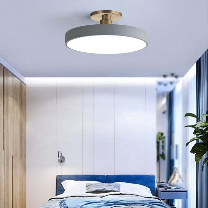 "Minimalist LED ceiling light, semi-flush design, brightens spaces with elegant style and energy-efficient glow."