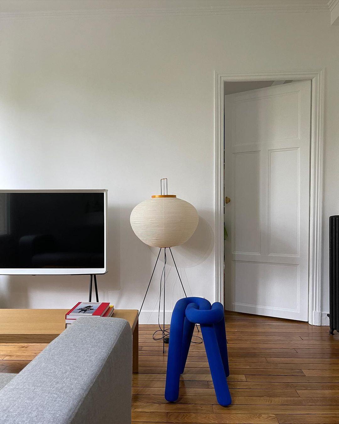 "Minimalist rice paper floor lamp with sleek metal frame and soft diffused light, perfect for creating a warm ambiance."