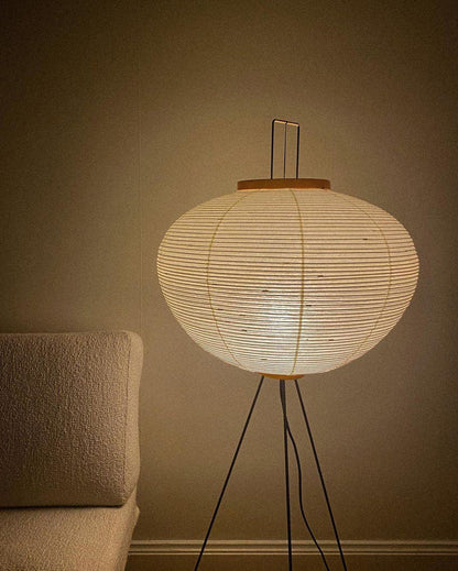 "Minimalist rice paper floor lamp with sleek metal frame and soft diffused light, perfect for creating a warm ambiance."