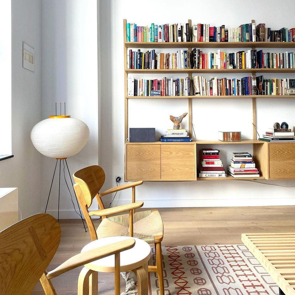 "Minimalist rice paper floor lamp with sleek metal frame and soft diffused light, perfect for creating a warm ambiance."