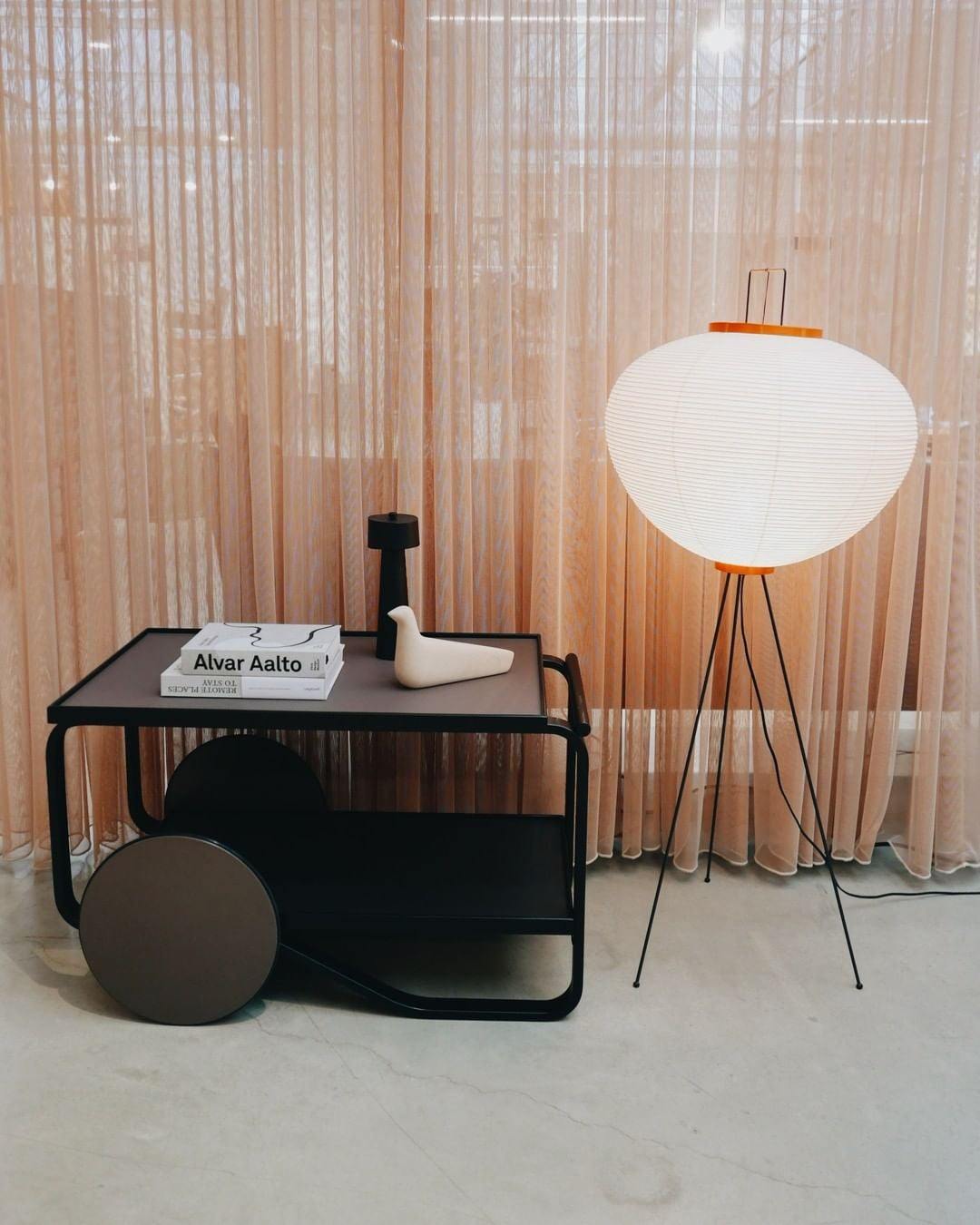 "Minimalist rice paper floor lamp with sleek metal frame and soft diffused light, perfect for creating a warm ambiance."