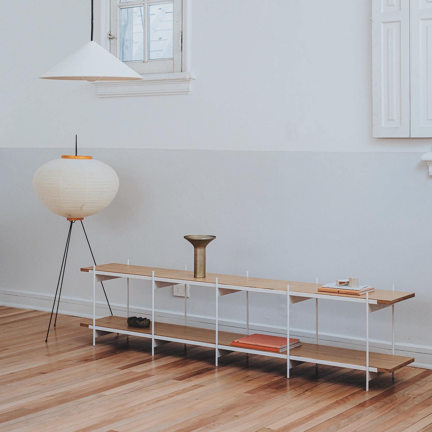 "Minimalist rice paper floor lamp with sleek metal frame and soft diffused light, perfect for creating a warm ambiance."