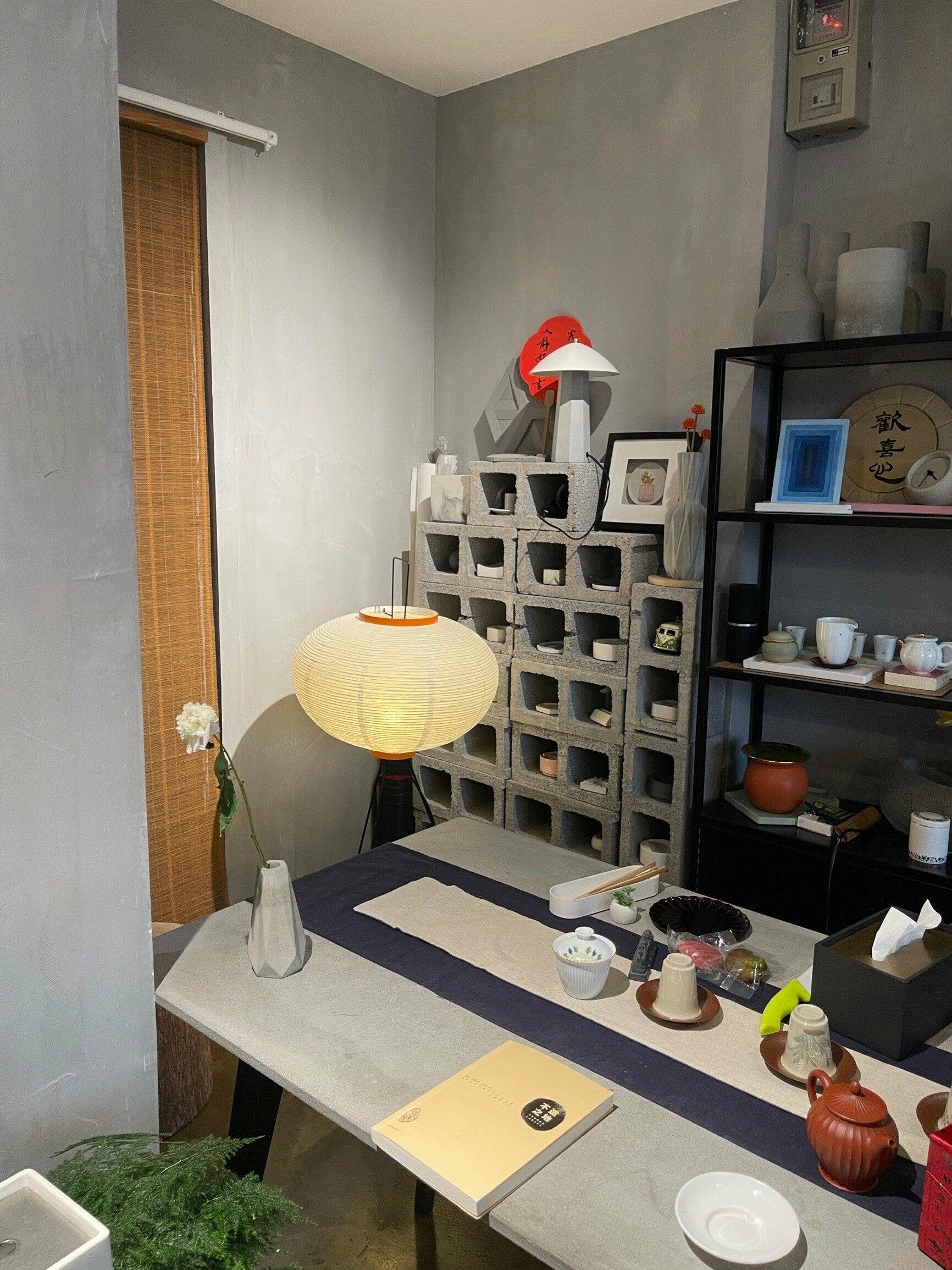 "Minimalist rice paper floor lamp with sleek metal frame and soft diffused light, perfect for creating a warm ambiance."