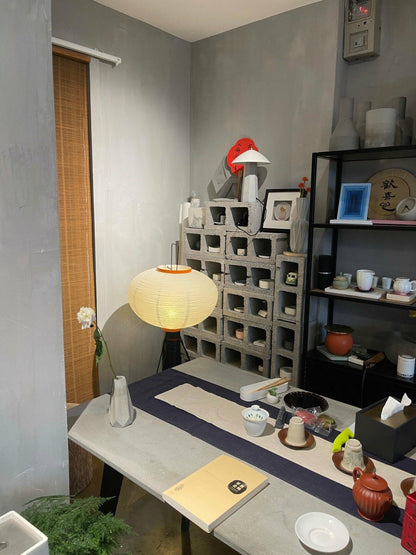 "Minimalist rice paper floor lamp with sleek metal frame and soft diffused light, perfect for creating a warm ambiance."