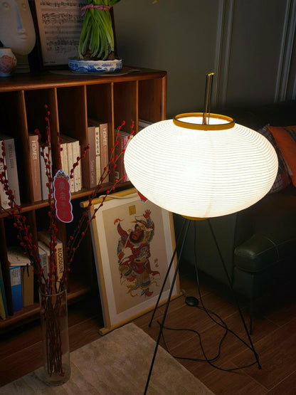 "Minimalist rice paper floor lamp with sleek metal frame and soft diffused light, perfect for creating a warm ambiance."