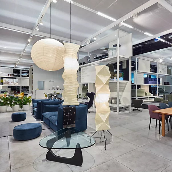 "Minimalist rice paper floor lamp with sleek metal frame and soft diffused light, perfect for creating a warm ambiance."