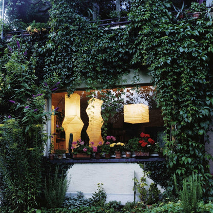 "Minimalist rice paper floor lamp with sleek metal frame and soft diffused light, perfect for creating a warm ambiance."