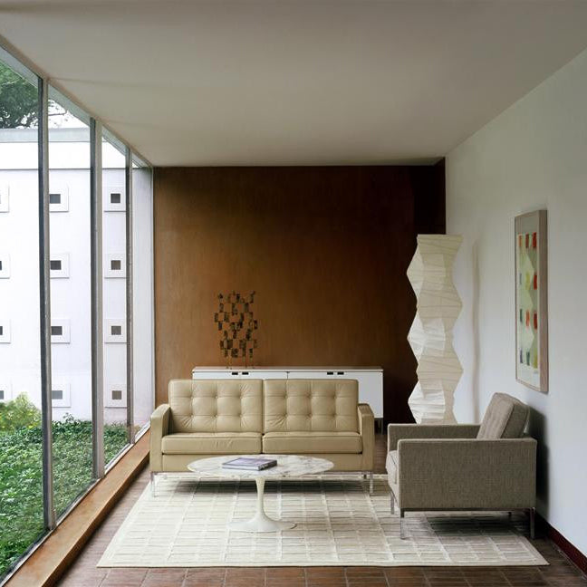 "Minimalist rice paper floor lamp with sleek metal frame and soft diffused light, perfect for creating a warm ambiance."