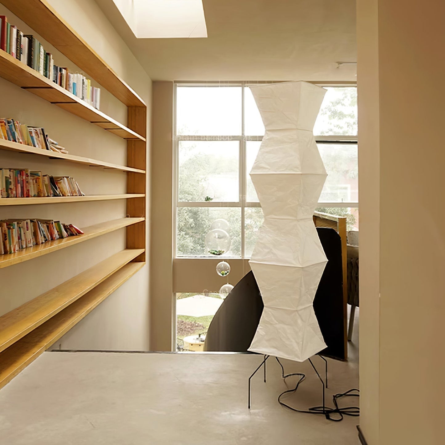 "Minimalist rice paper floor lamp with sleek metal frame and soft diffused light, perfect for creating a warm ambiance."