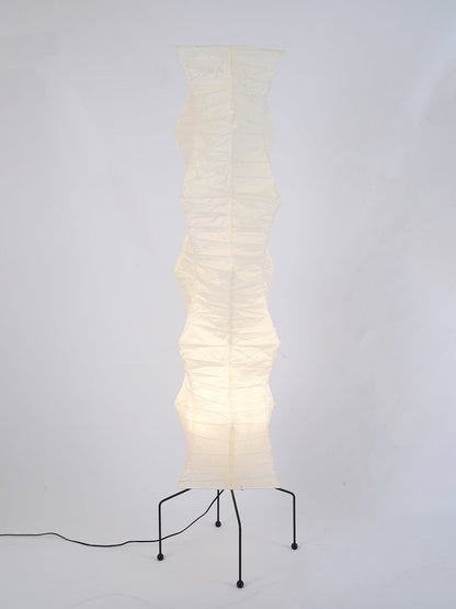 "Minimalist rice paper floor lamp with sleek metal frame and soft diffused light, perfect for creating a warm ambiance."
