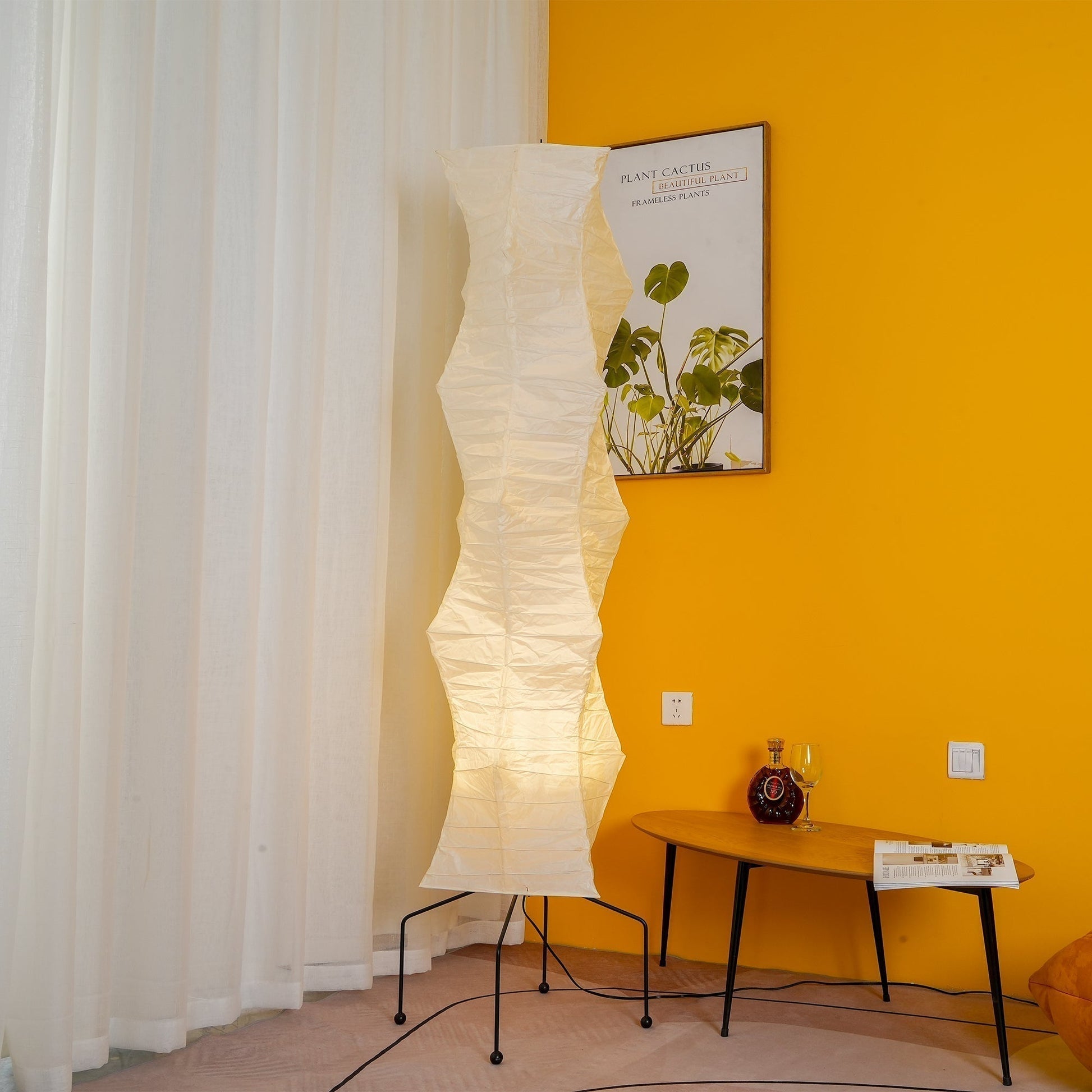 "Minimalist rice paper floor lamp with sleek metal frame and soft diffused light, perfect for creating a warm ambiance."